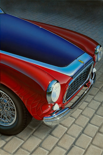 1951 Ferrari 212E close-up image of the front, angular view. Car is a beautiful red with a dark and light blue hood. 